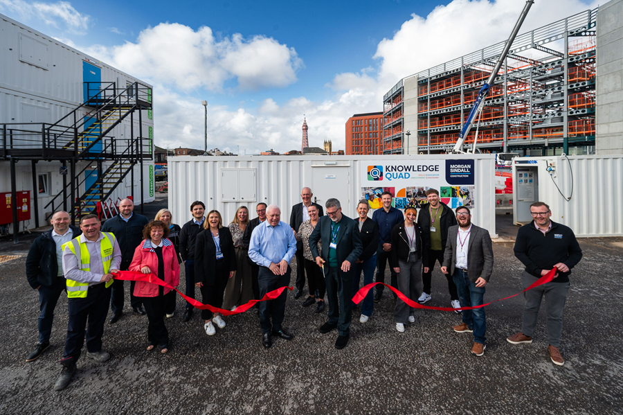 A group of people cutting a ribbon